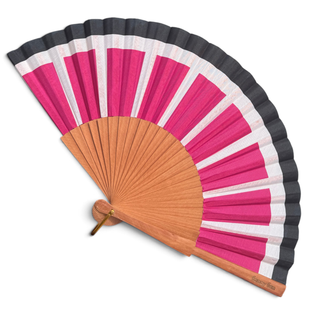 LE BAZAR INOUI SUN RAYS Handfächer aus Holz mit pink-weiß-schwarzem Streifenmuster und Stoffbespannung.